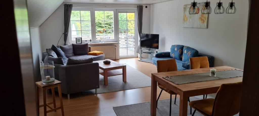 a living room with a couch and a table at Ferienwohnung mit Dachterrasse in Eicklingen