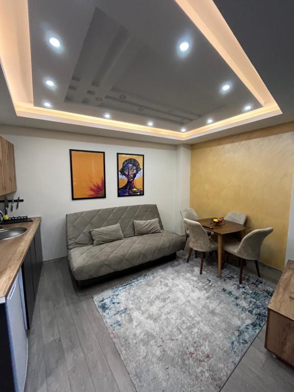 a living room with a couch and a table at Square Vanilla Apartments in Skopje