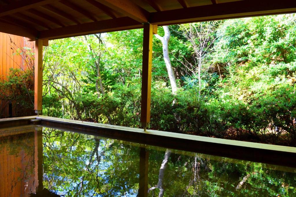 a view of a forest from the porch of a house at VIVI Atami Shizenkyo Room 3001 - Vacation STAY 14277 in Atami