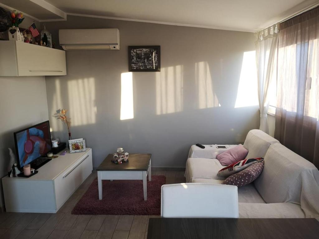 a living room with a white couch and a table at Veio Terrace in Rome