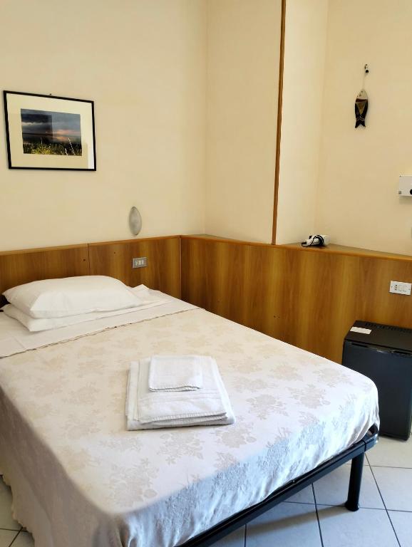 Postel nebo postele na pokoji v ubytování Albergo Rosa & Cosetta