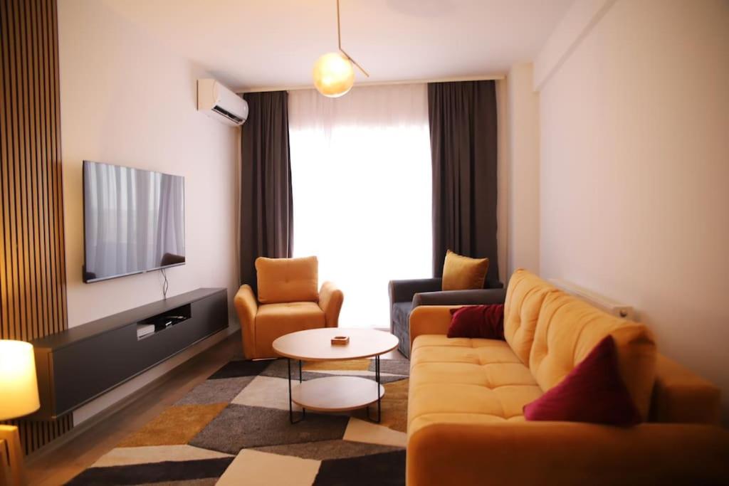 a living room with a couch and a tv at SKY Apartment in Kosovo Polje