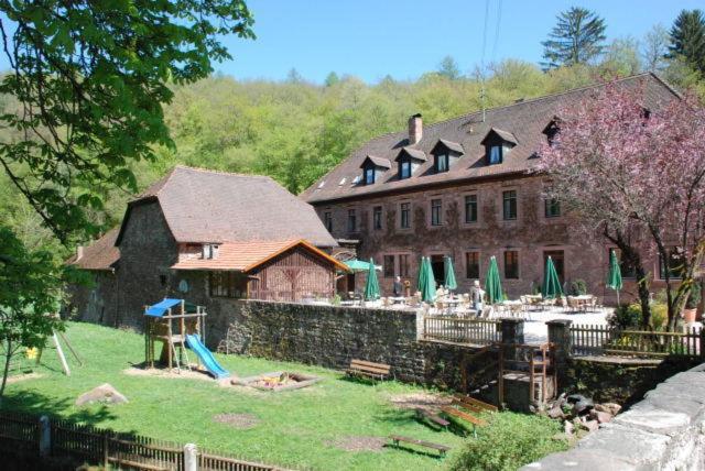 a large building with a playground in front of it at Hotelgasthof Buchenmühle in Lohr