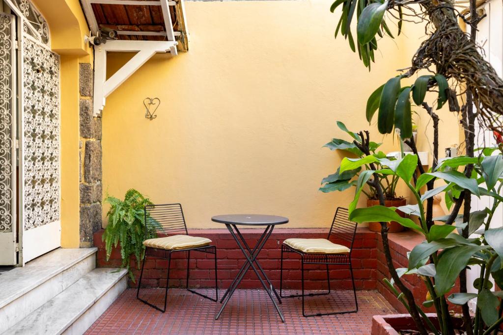 a table and two chairs on a patio at Chez Zany Boutique Hostel - Copacabana in Rio de Janeiro