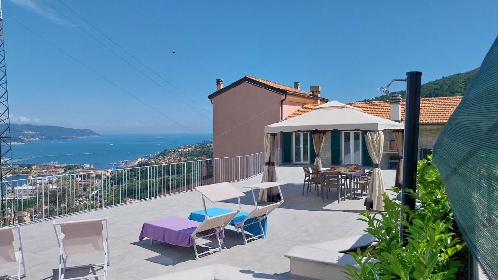 a patio with a table and chairs and an umbrella at vignale holiday house in La Spezia