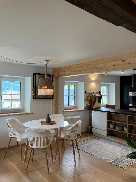 a kitchen and dining room with a table and chairs at Anno 1763 in St. Wolfgang