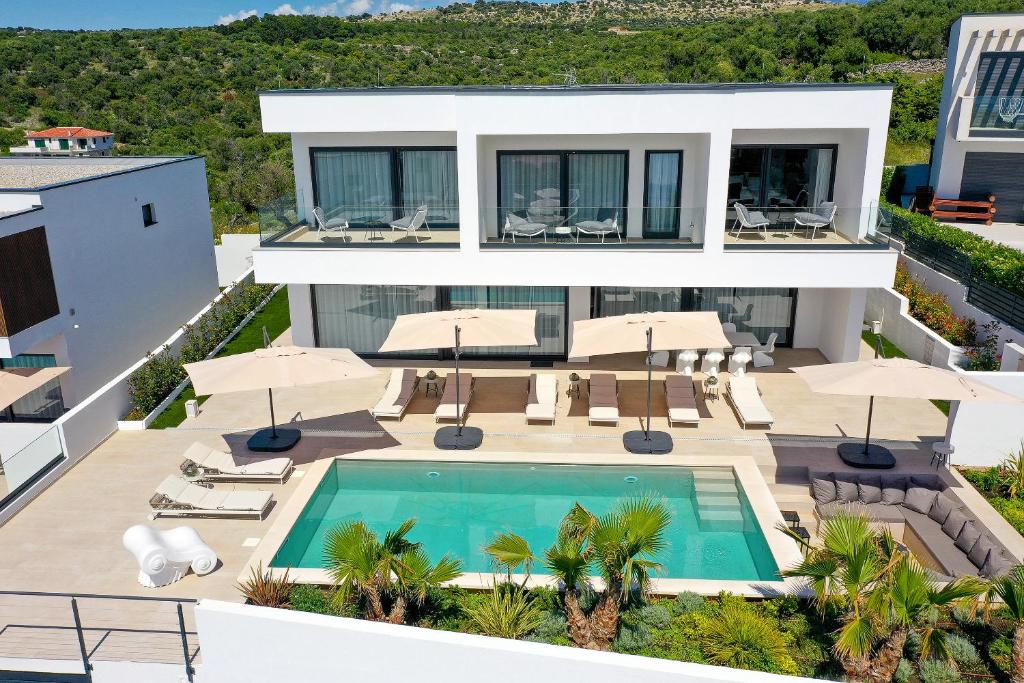 an aerial view of a house with a swimming pool at Luxury Villa 360 - private heated pool in Novalja