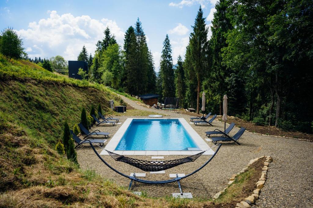 a swimming pool with lounge chairs around it at PROSTIR in Korostov