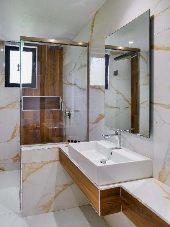 a bathroom with a sink and a mirror at Villa Tonia in Himare