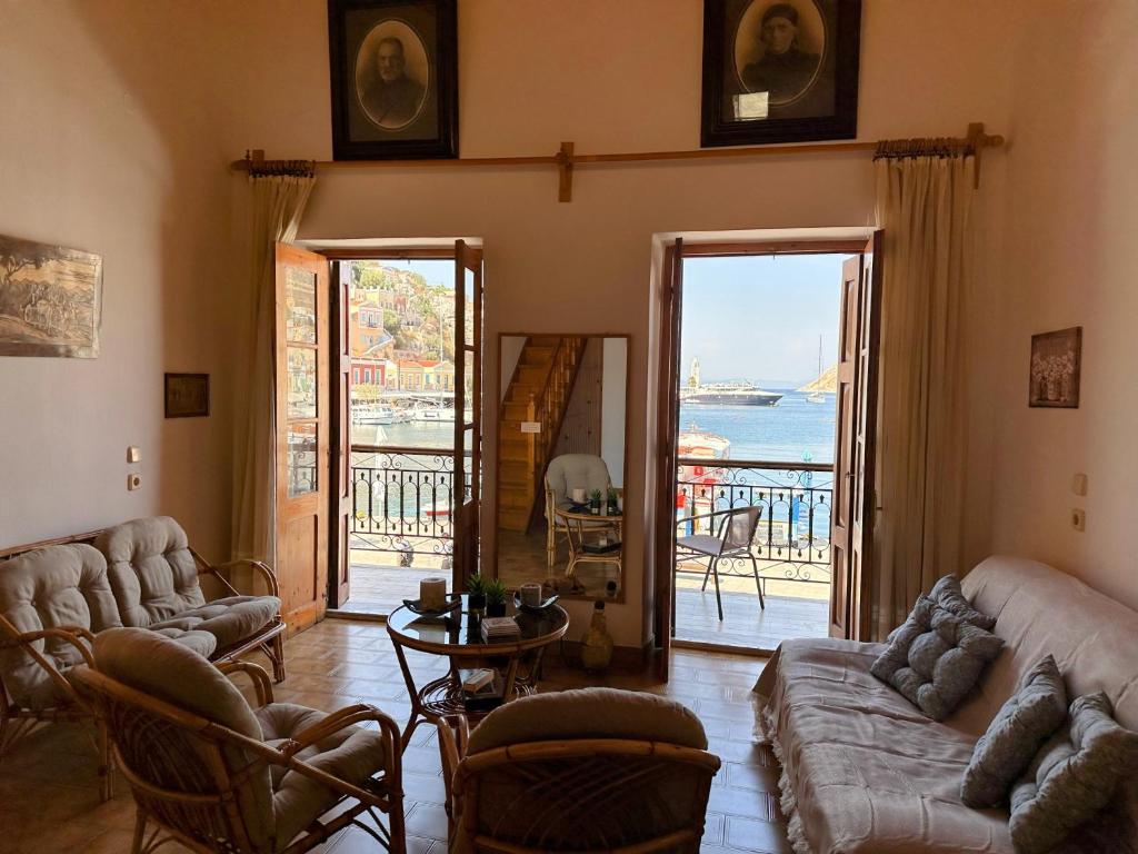a living room with couches and a view of the ocean at Amorosa House in Symi