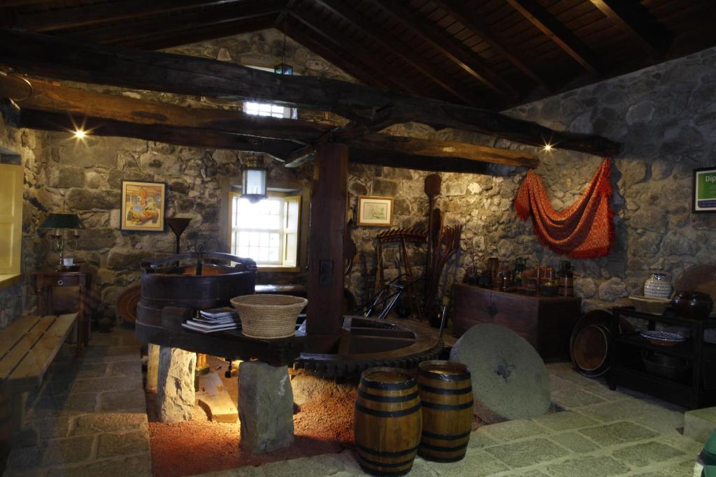 a room with a kitchen with a sink and barrels at Quinta das Buganvílias in Castelo Branco