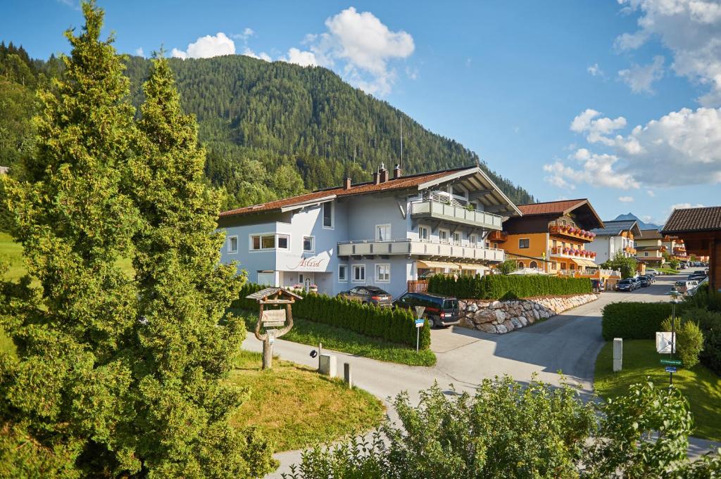 un grand bâtiment avec une montagne en arrière-plan dans l'établissement Ferienhaus Astrid, à Flachau