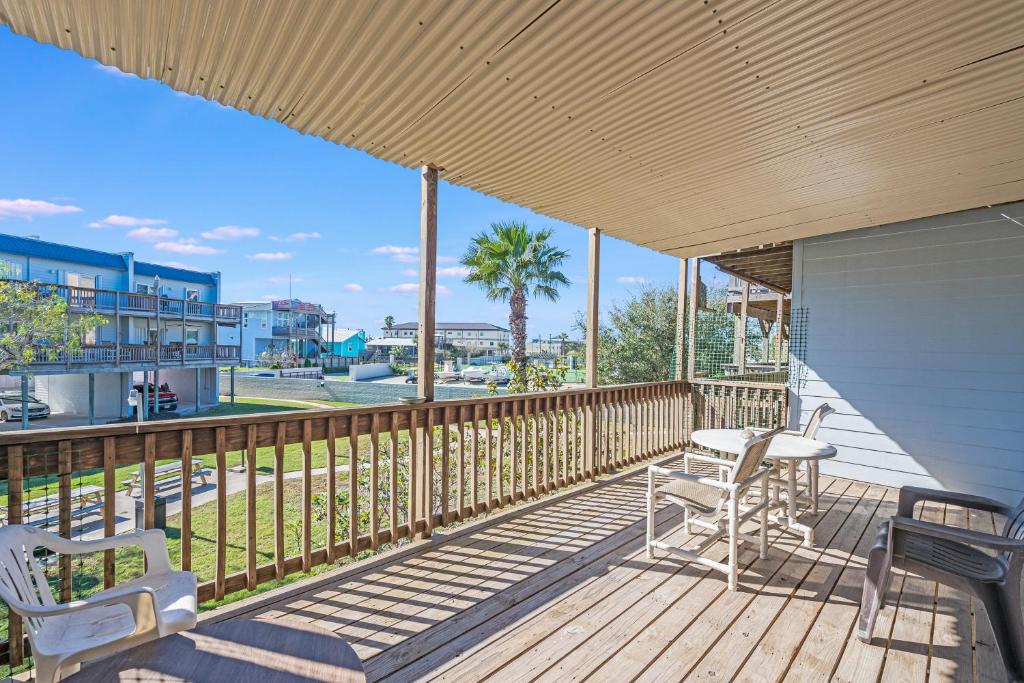 a deck with two chairs and a table on it at Bay Tree B78 in Port Aransas
