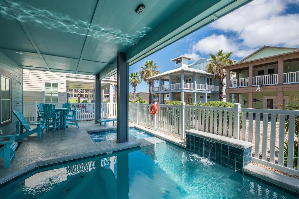 a house with a swimming pool on a balcony at Marlin Madness BB909 in Port Aransas