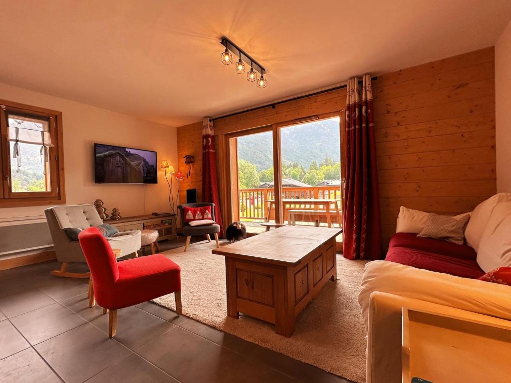 a living room with a bed and a table at Duplex spacieux proche des remontées, balcon, animaux admis, WIFI - FR-1-624-13 in Samoëns