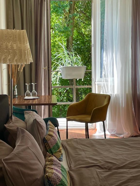 a living room with a couch and a chair and a window at SURF HOUSE DREAMERS COAST in Klaipėda