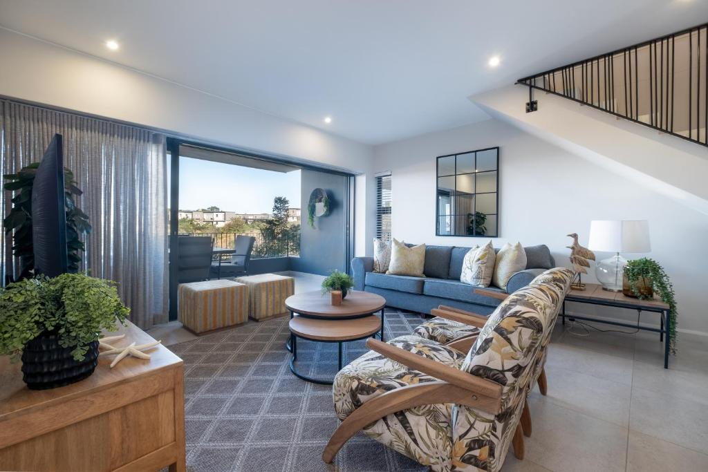 a living room with a couch and a table at Moyana 14 in Ballito