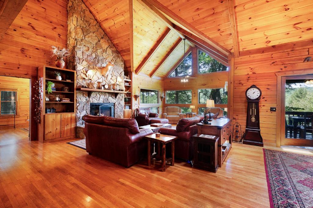 a living room with a couch and a fireplace at Hazy Hideaway with View of Ellijay River in the North GA Mountains in Cherry Log
