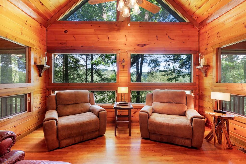 two chairs and a table in a room with windows at Hazy Hideaway with View of Ellijay River in the North GA Mountains in Cherry Log
