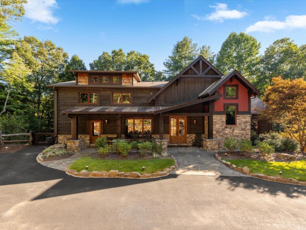an exterior view of a house with a driveway at River Joy Lodge - Luxury Home on the Ellijay River in Cherry Log