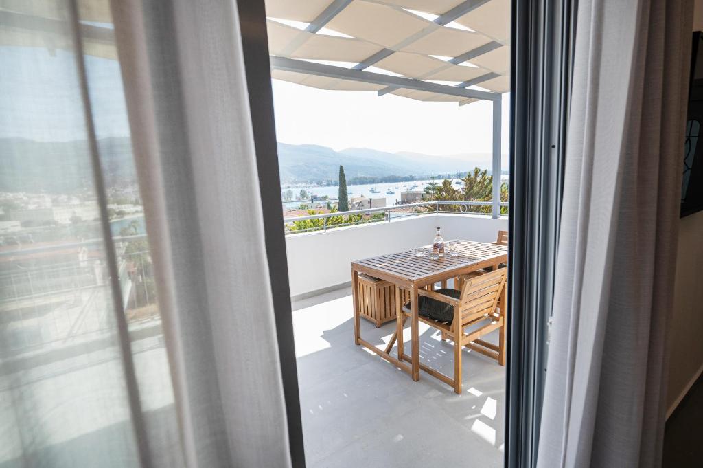 a balcony with a table and a view of the city at Sophie's Apartments 5 & 6 in Poros