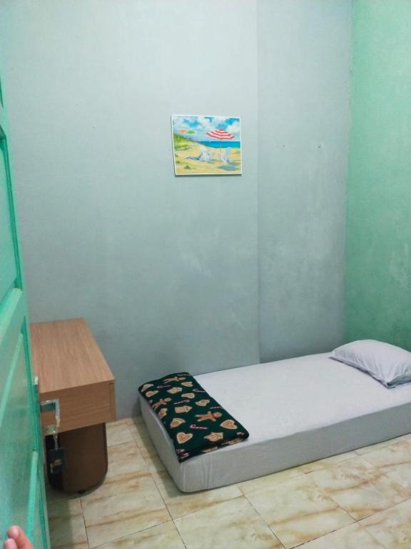 Postel nebo postele na pokoji v ubytování Mandeh Guesthouse Padang