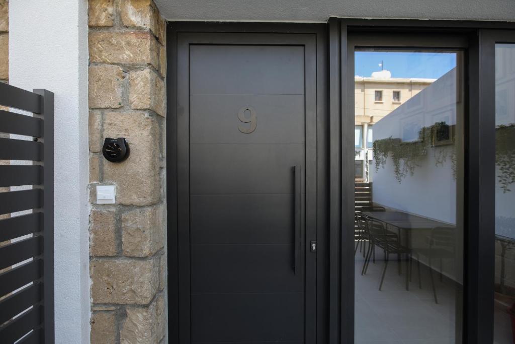 a black door with a handle on a building at PanMari in Paphos
