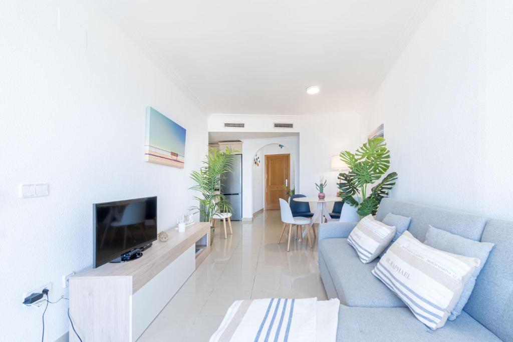 A television and/or entertainment centre at BADIA DE ROSES 2 new apartment