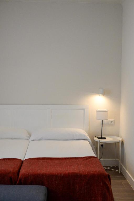 Postel nebo postele na pokoji v ubytování Hostal Jakiton