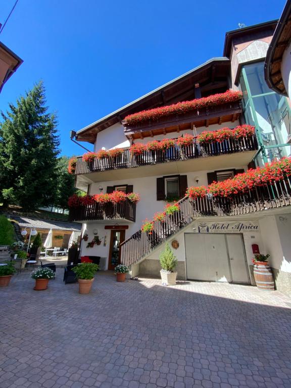 a building with lots of flowers on the balconies at Albergo Aprica Garni in Aprica
