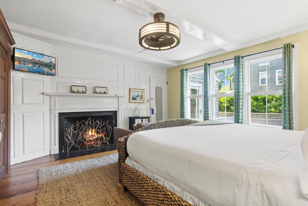 a bedroom with a bed and a fireplace at Carlisle House Inn in Nantucket