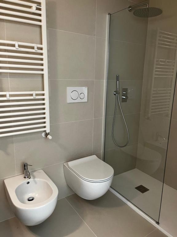 a bathroom with a shower and a toilet and a sink at Casita in Santo Spirito