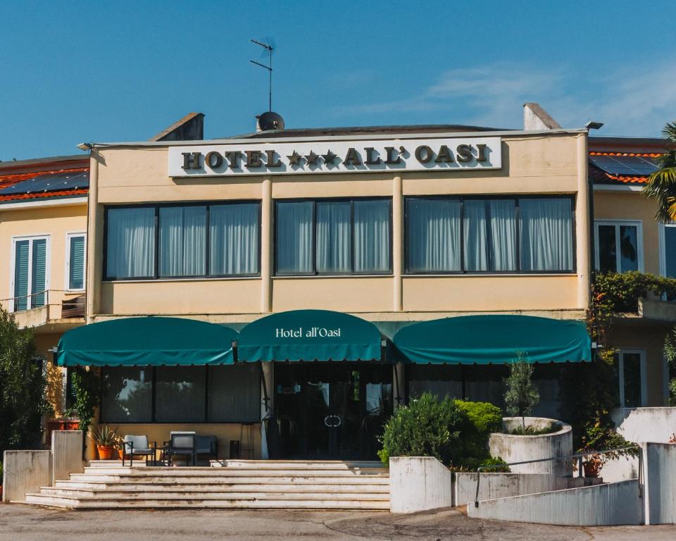 a hotel with a sign on the front of it at Hotel all'Oasi in Paese