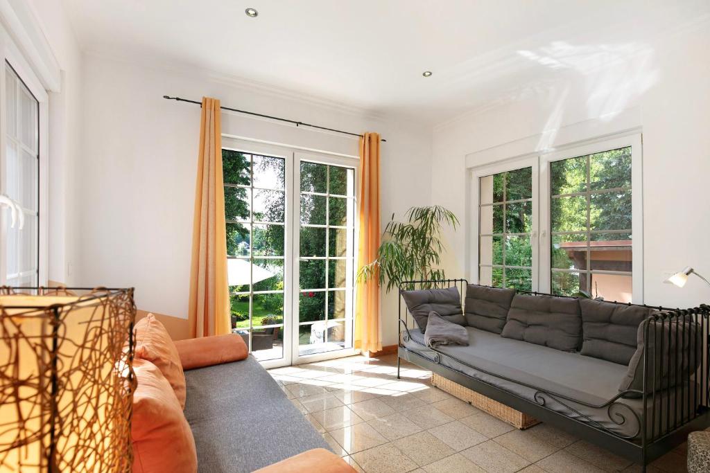 a living room with a couch and some windows at Ferienwohnung Bestensee in Bestensee