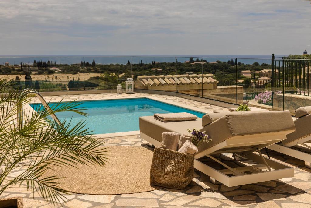 basen z leżakami i widokiem na ocean w obiekcie Ipoliti Luxury Living w mieście Svoronata