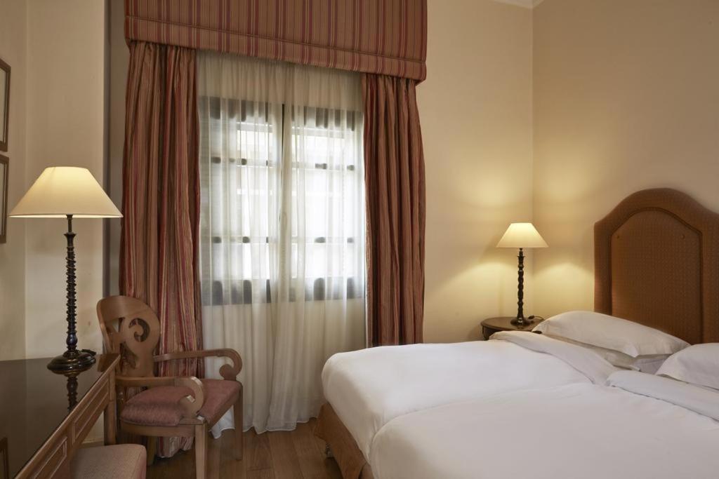 Postel nebo postele na pokoji v ubytování The Captain's House Boutique Hotel