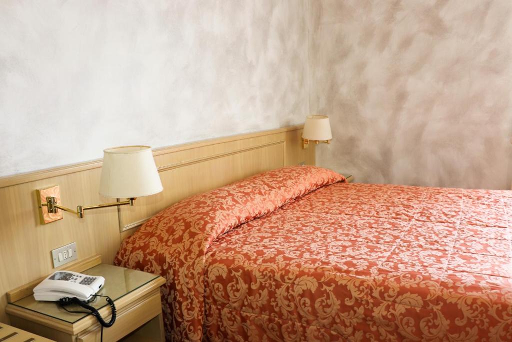 Postel nebo postele na pokoji v ubytování Hotel Garni del Lago