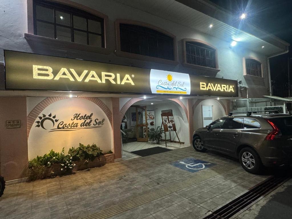 a car parked in front of a bawaria store at Hotel y Restaurante Costa del Sol in Mata de Limón