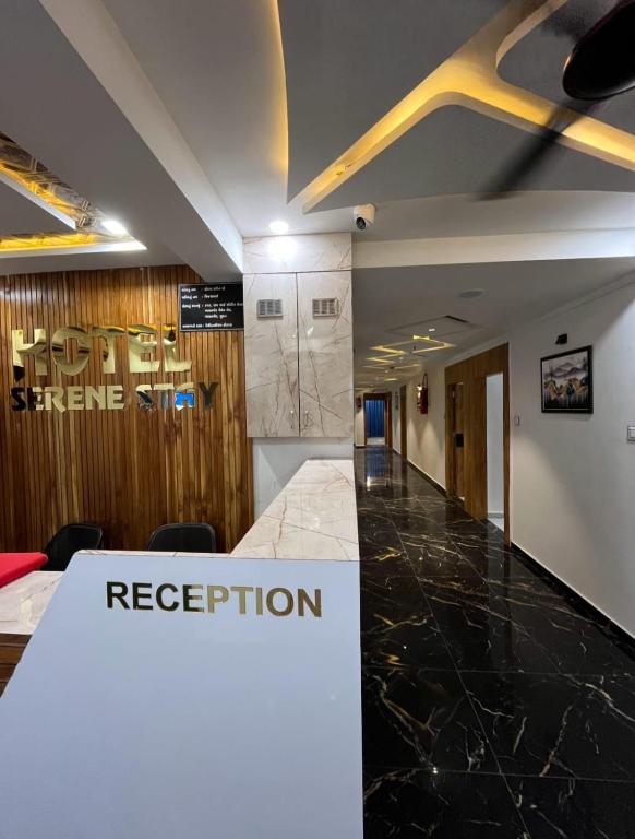 a conference room with a reception sign on the wall at Hotel SERENE STAY in Surat
