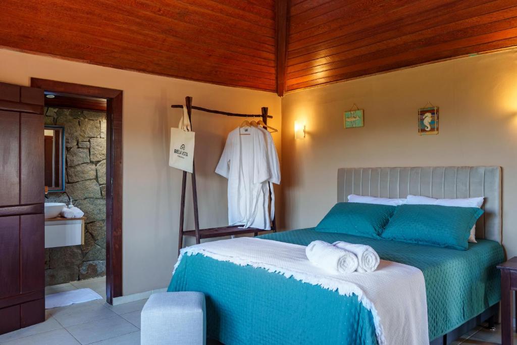 a bedroom with a bed with towels on it at Bela Vista Ferradura in Búzios