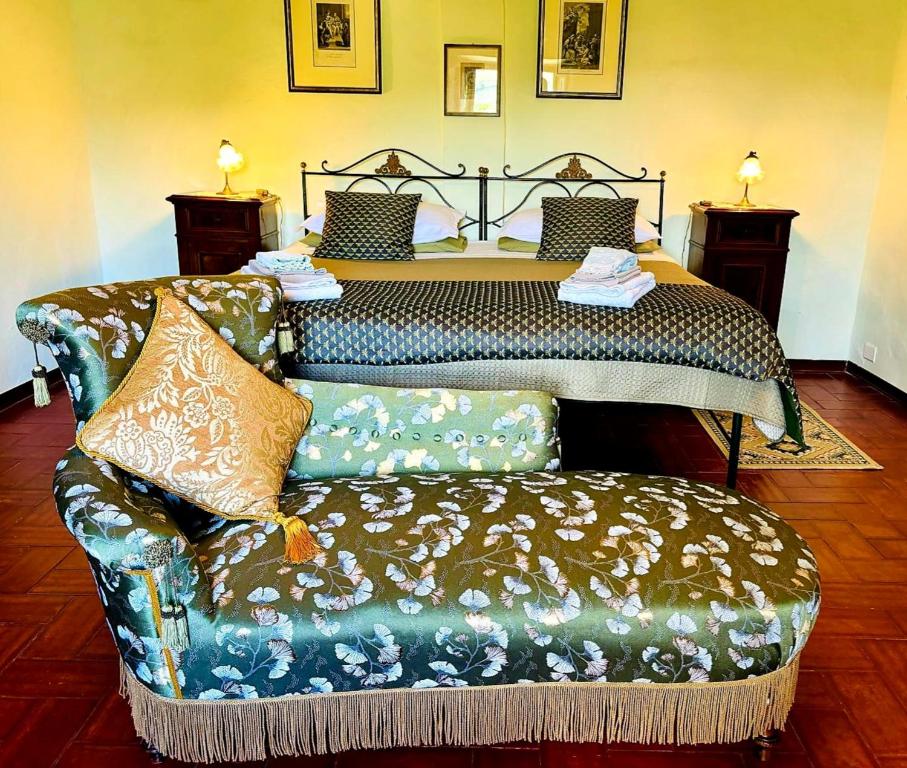 a bedroom with a bed and a couch with a bed at Casa Stella Country House in Savigno