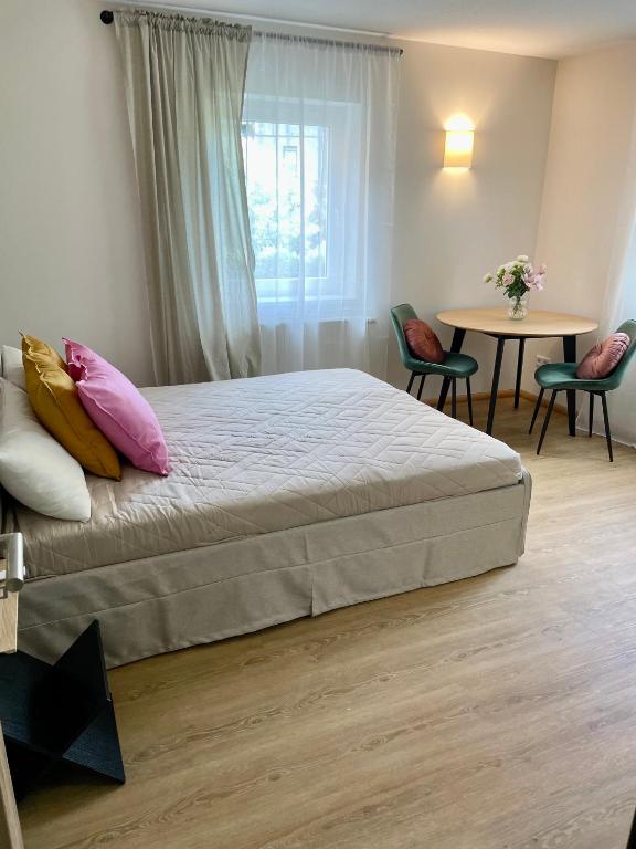 a bedroom with a bed and a table with chairs at Visit Oberhof 1 in Oberhof