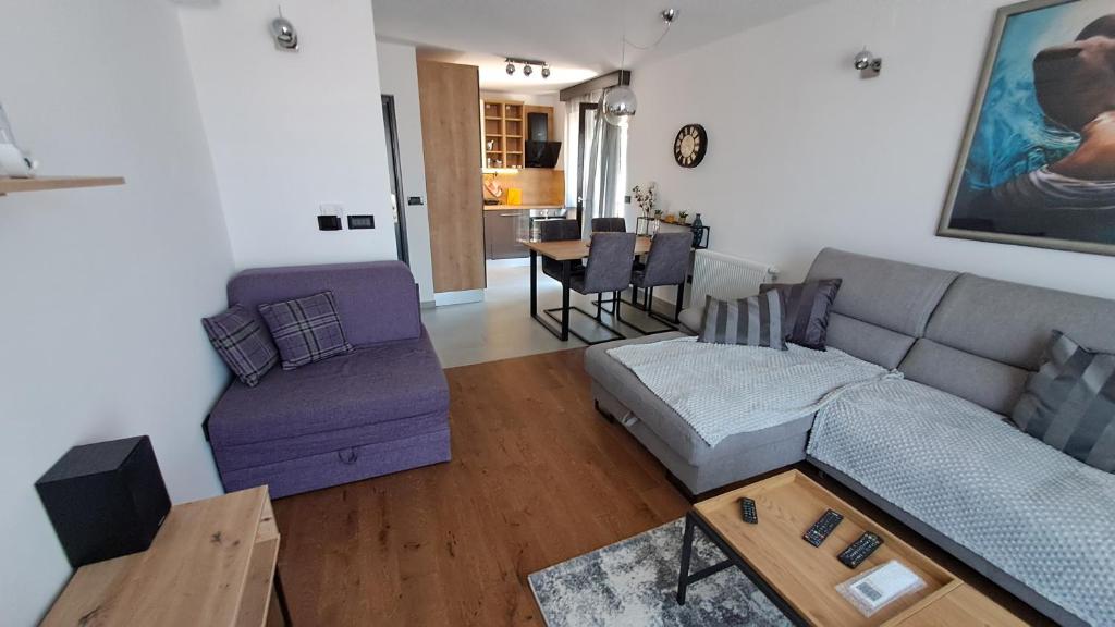 a living room with a couch and a table at Apartman NAR Murter in Murter