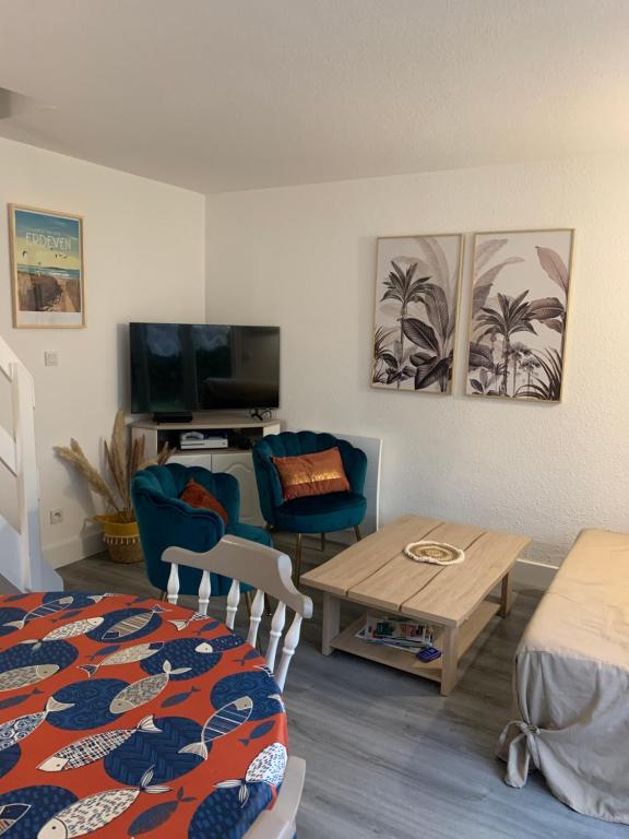 un salon avec un lit, une table et un canapé dans l'établissement Charmante maison avec piscine , plage à 500 m , location du samedi au samedi !!!, à Erdeven