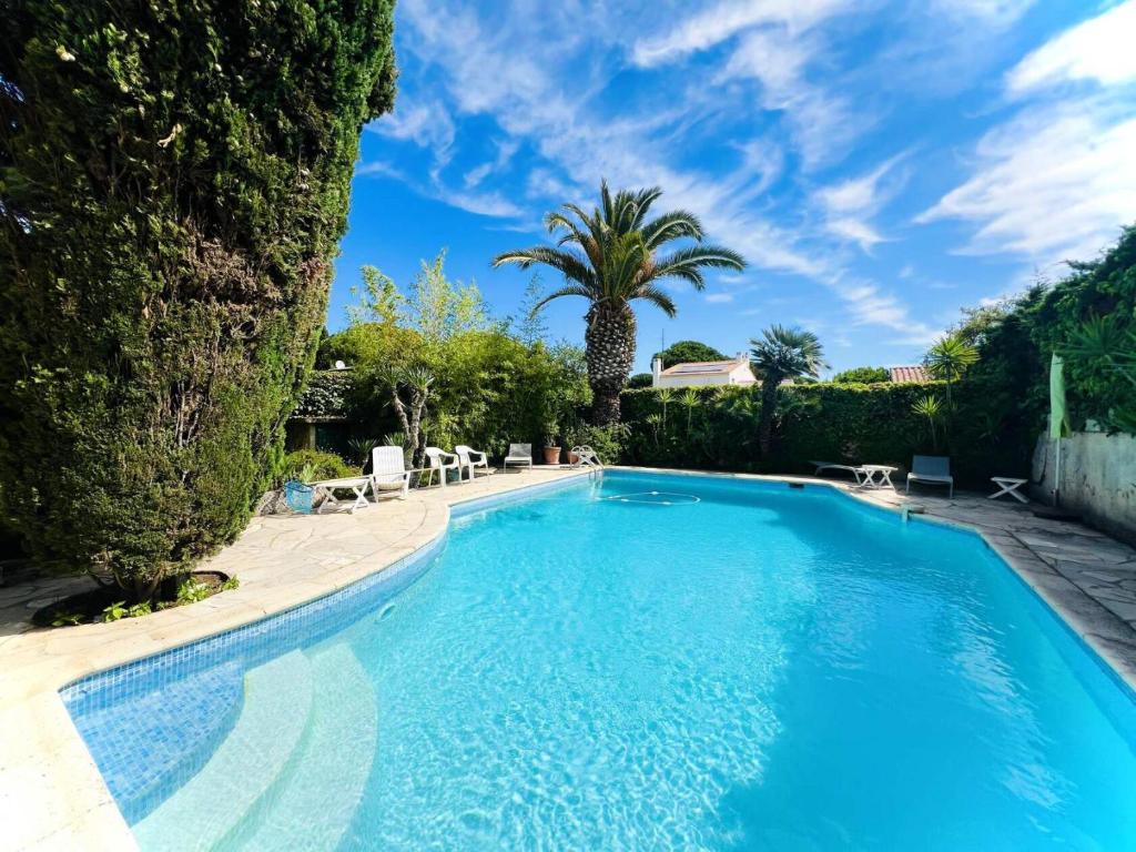 une piscine dans une cour avec un palmier dans l'établissement Villa Farniente - Villa idéale pour les familles MAE-4114, à La Grande Motte