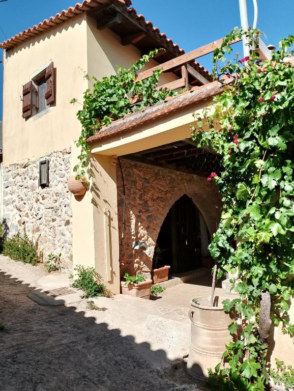 an entrance to a building with flowers on it at Orgon Farm Village Houses in Apóstoloi