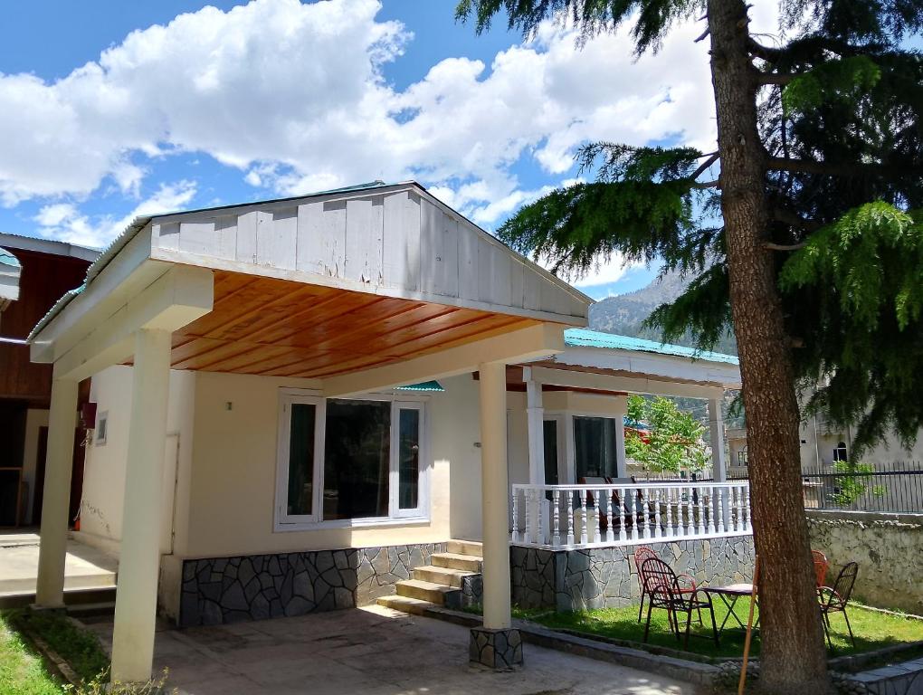 a small house with a wooden roof and a porch at Available for Kalam in Kalām