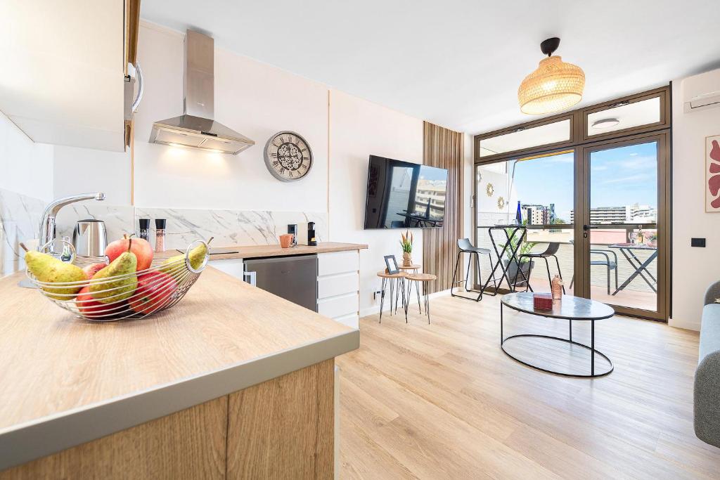 a kitchen with a bowl of fruit on a counter at BeachSide Maspalomas FKK friendly in Maspalomas