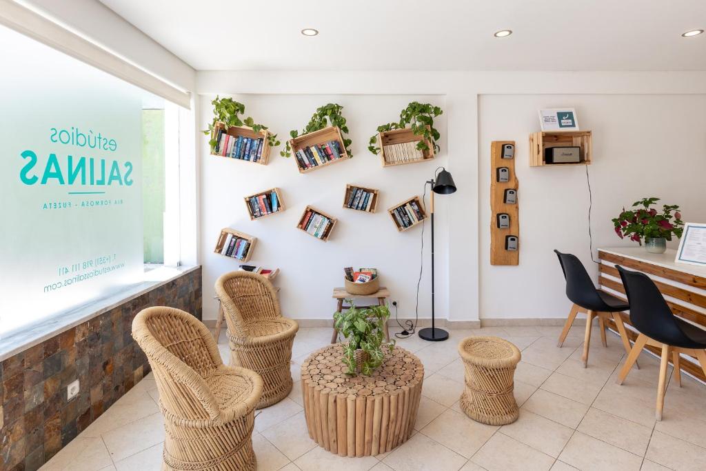 a room with wicker chairs and a table at Estudios Salinas - Fuseta in Fuzeta