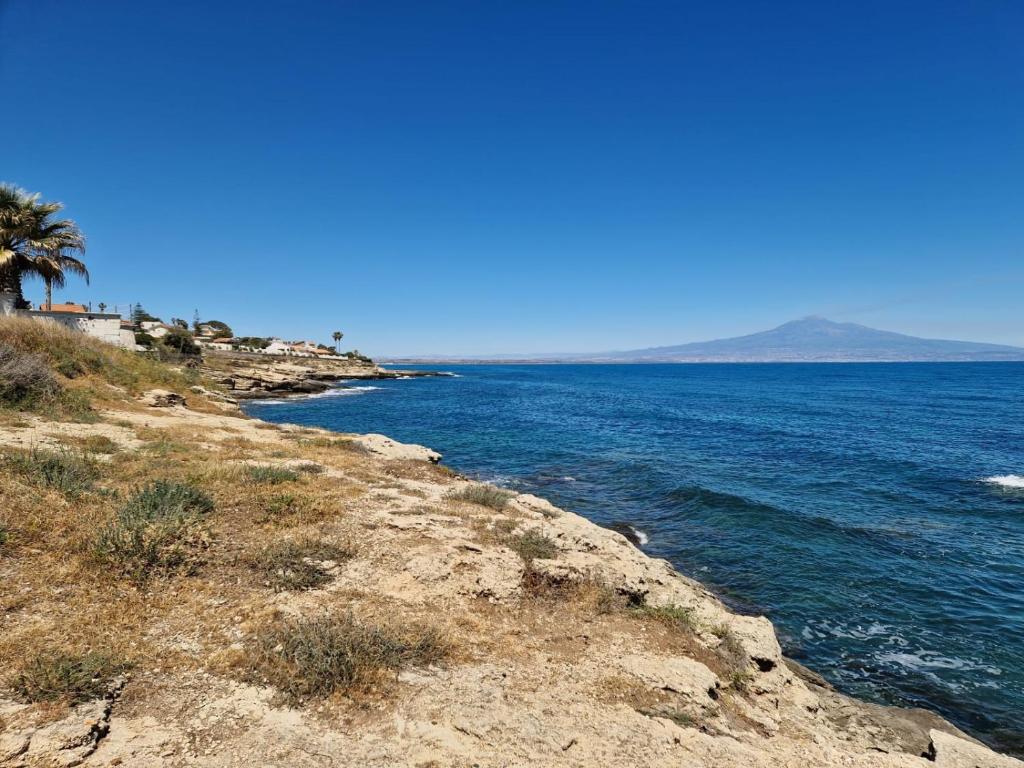 a view of the ocean from a rocky shore at Villa Baia del Silenzio in Agnone Bagni